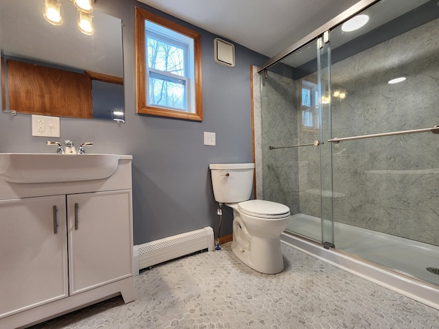 bathroom featuring tile patterned floors, a baseboard heating unit, vanity, toilet, and a shower with shower door