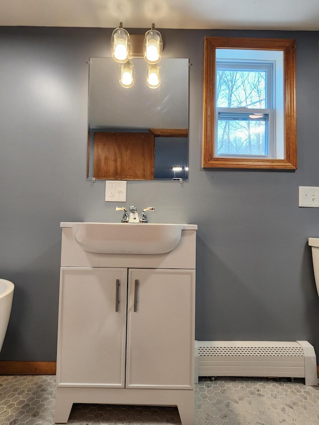 bathroom with vanity, a baseboard heating unit, and tile patterned floors