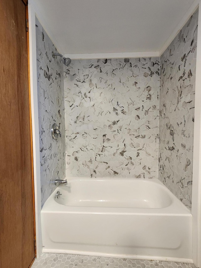 bathroom featuring a bathing tub, crown molding, and tile patterned floors