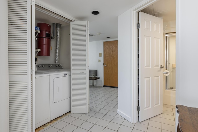 clothes washing area with light tile patterned floors and washing machine and dryer