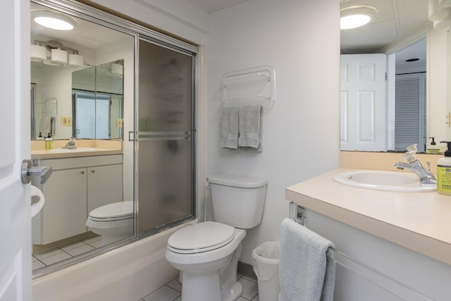 full bathroom with tile patterned flooring, vanity, toilet, and combined bath / shower with glass door