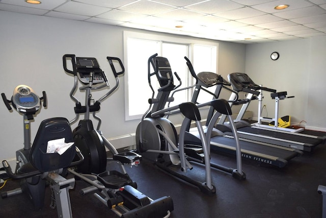 workout area with a drop ceiling and a healthy amount of sunlight