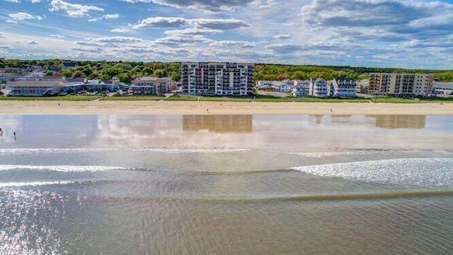 birds eye view of property featuring a water view and a view of the beach