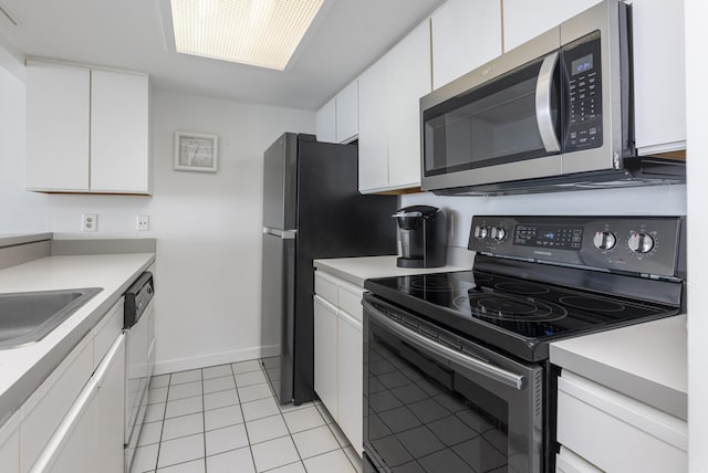 kitchen featuring light tile patterned flooring, stainless steel appliances, sink, and white cabinets