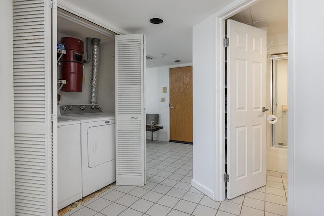 clothes washing area featuring washing machine and dryer and light tile patterned flooring