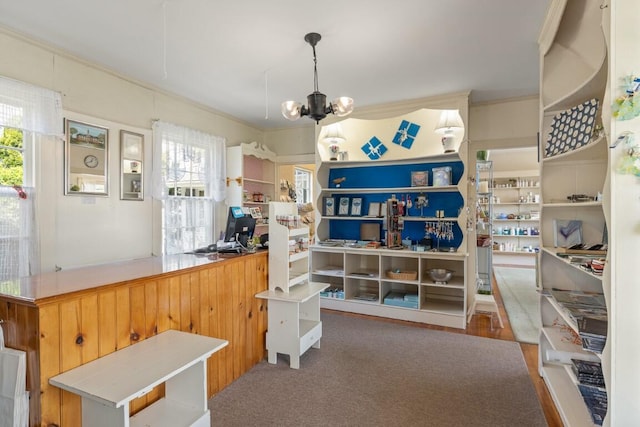 interior space with plenty of natural light, crown molding, and a notable chandelier