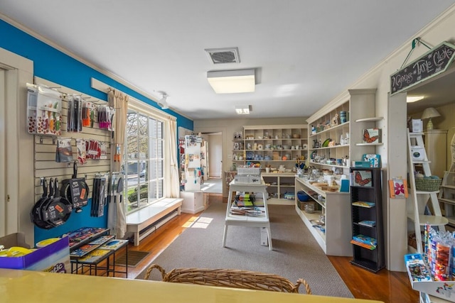 interior space with ornamental molding and carpet flooring