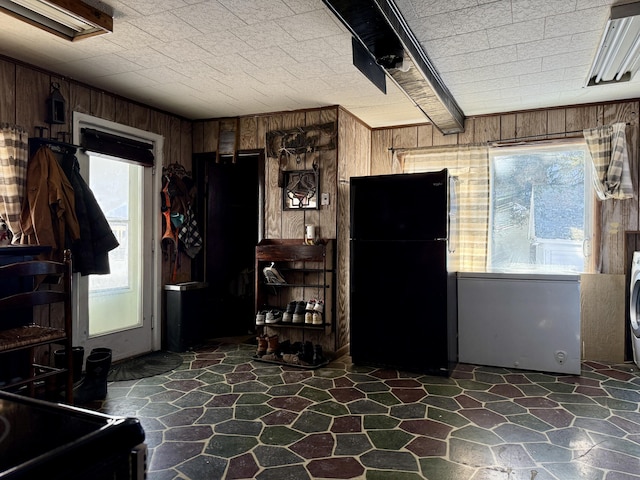 misc room with wood walls and washer / clothes dryer