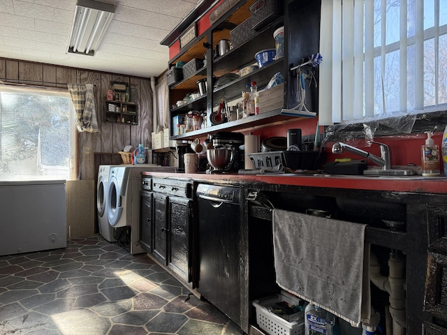 laundry room with wood walls and independent washer and dryer