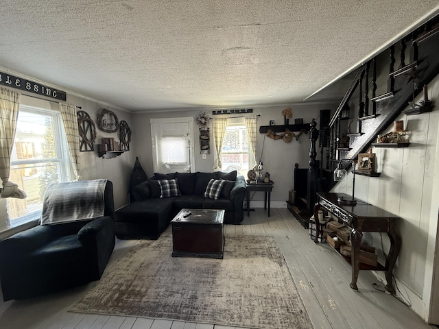 living room featuring light wood-type flooring and a textured ceiling