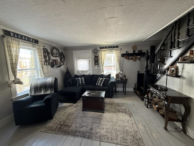 living room with light hardwood / wood-style floors, plenty of natural light, and a textured ceiling