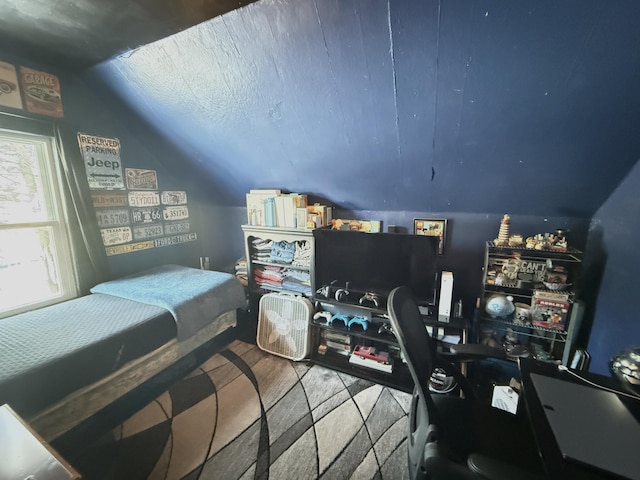 bedroom with wood-type flooring and vaulted ceiling