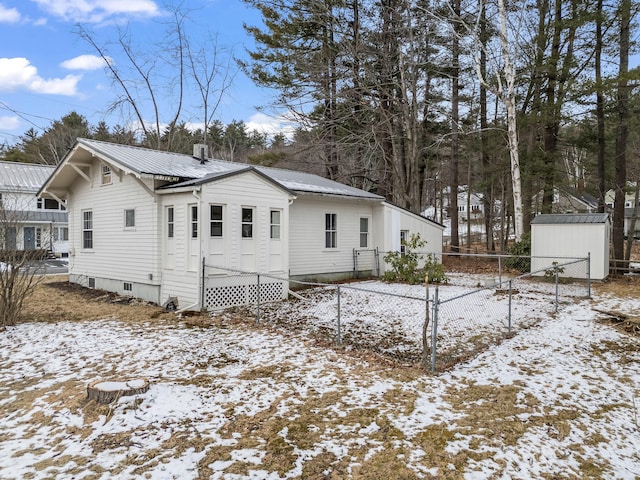 view of snowy exterior featuring a storage shed