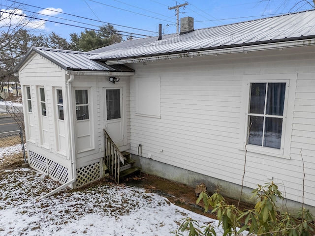 view of snow covered rear of property