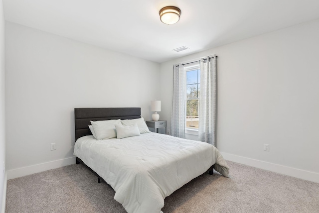 carpeted bedroom featuring visible vents and baseboards