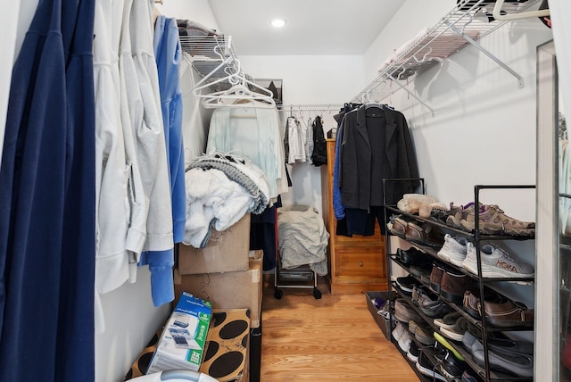 walk in closet with wood finished floors