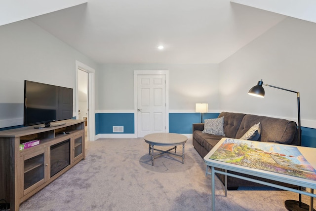 carpeted living area featuring visible vents and baseboards