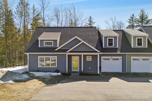 view of front of house with aphalt driveway, a shingled roof, and a garage