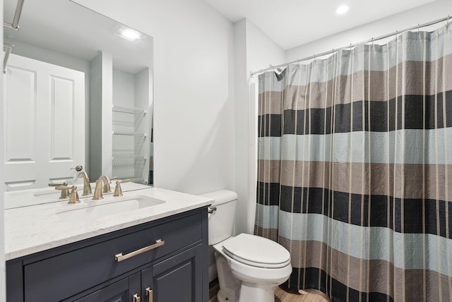 bathroom with vanity, curtained shower, and toilet