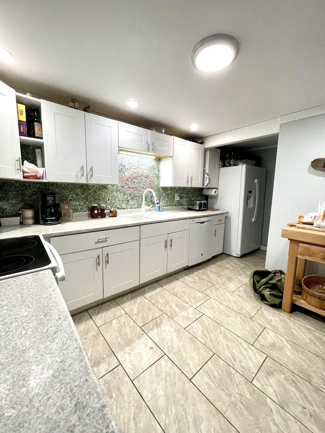 kitchen with white cabinetry, white appliances, sink, and tasteful backsplash