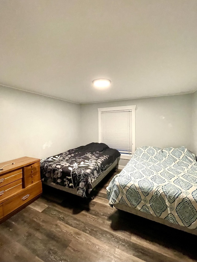 bedroom with dark hardwood / wood-style floors