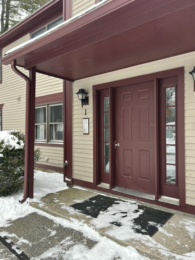 view of snow covered property entrance