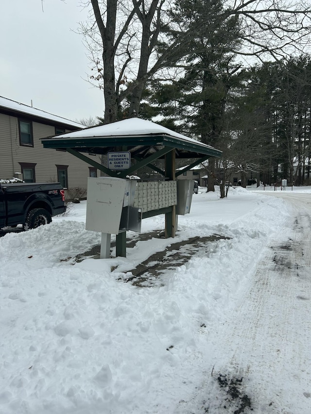 yard covered in snow with mail boxes