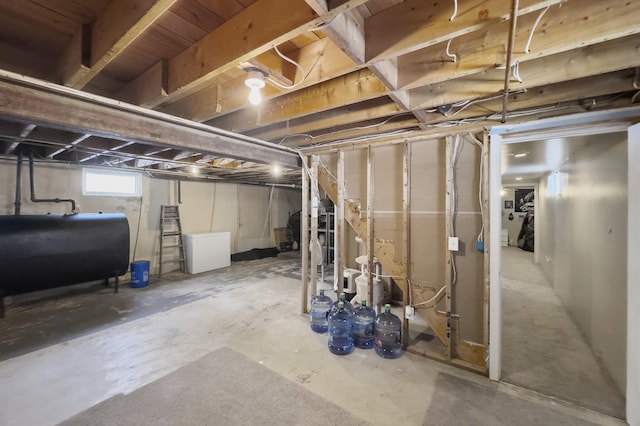 basement with refrigerator and heating fuel