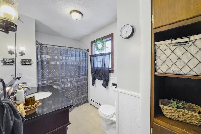 full bath featuring toilet, a baseboard radiator, curtained shower, a textured ceiling, and vanity