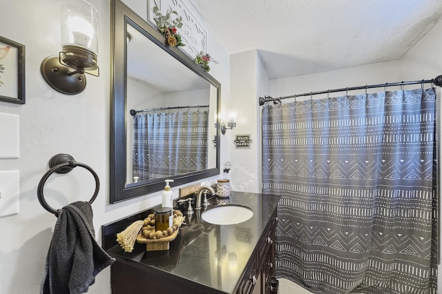 full bath featuring a shower with curtain, vanity, and a textured ceiling