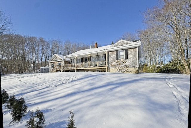 view of front of property with a deck and a chimney