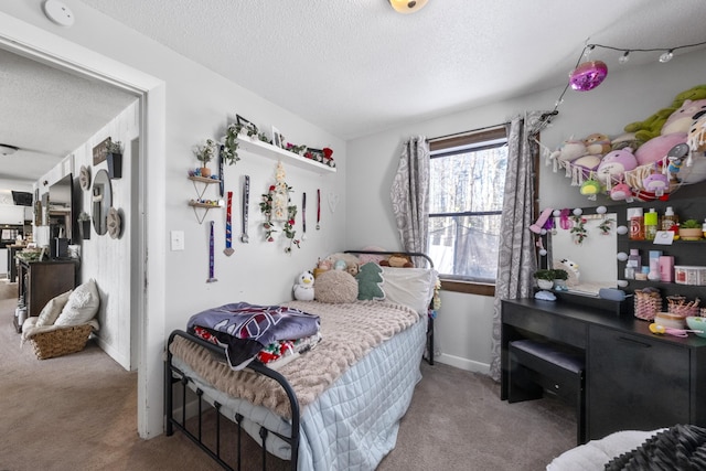 bedroom featuring carpet floors, a textured ceiling, and baseboards