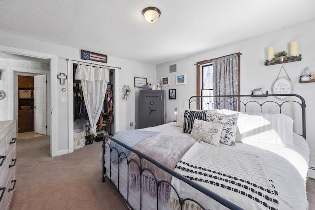 bedroom with a textured ceiling, a closet, and carpet