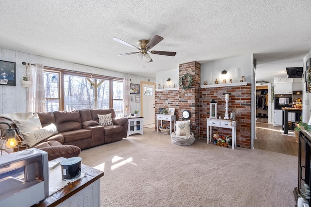 carpeted living room with a wood stove, a textured ceiling, and a ceiling fan