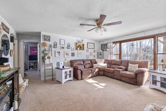 carpeted living room with ceiling fan and a textured ceiling