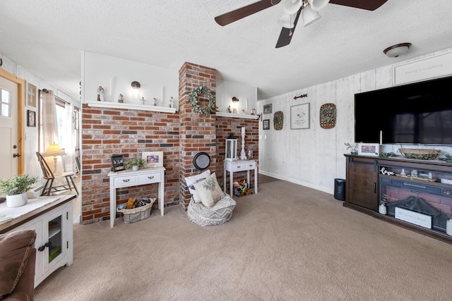 living room featuring a textured ceiling, carpet flooring, and a ceiling fan