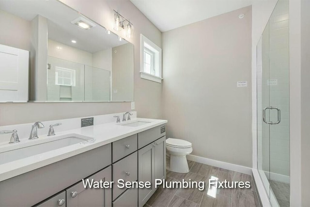 170 Buttonbush Ln Unit 21, Wells, ME 04090 - full bathroom with a shower stall, toilet, double vanity, and baseboards