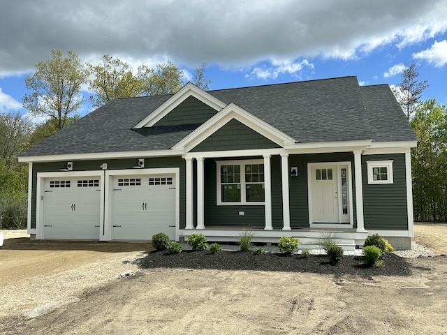 170 Buttonbush Ln Unit 21, Wells, ME 04090 - view of front of home featuring covered porch, an attached garage, a shingled roof, and driveway