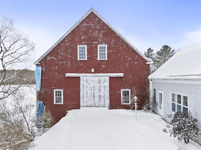 view of snow covered rear of property