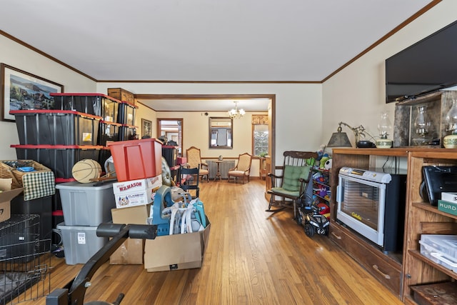 interior space with heating unit, radiator, hardwood / wood-style flooring, and ornamental molding