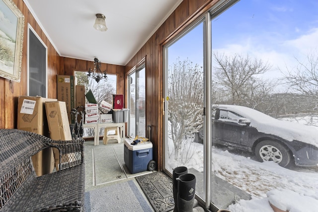 sunroom / solarium with an inviting chandelier