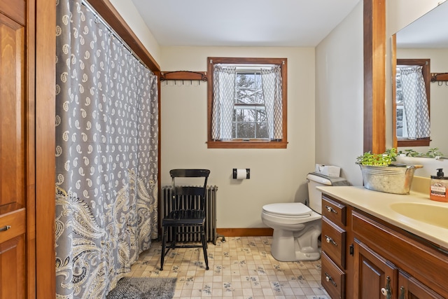 bathroom with vanity, radiator, and toilet