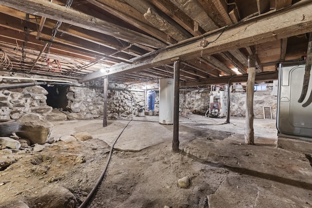 basement featuring water heater and heating unit