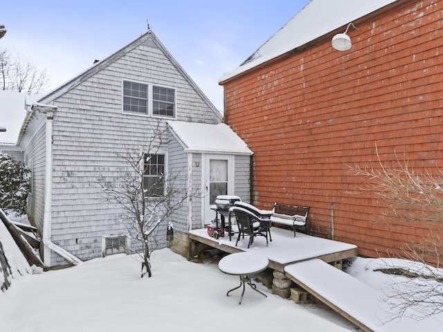 view of snow covered rear of property