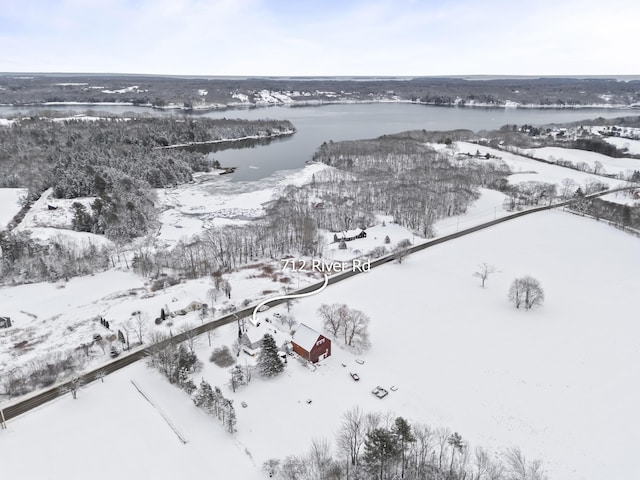 snowy aerial view featuring a water view