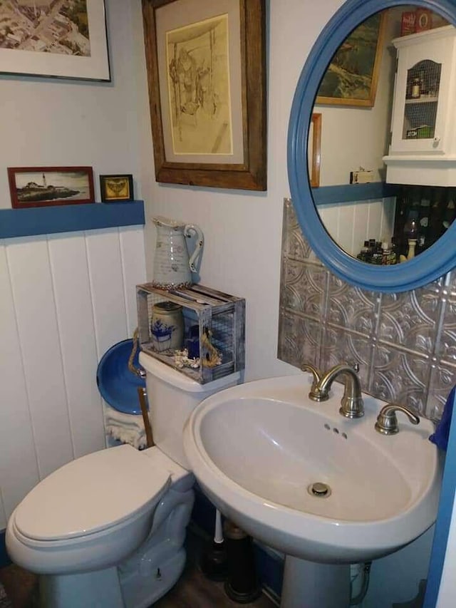 half bathroom featuring toilet and a sink