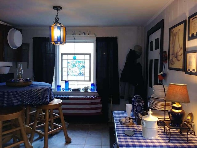 tiled dining area featuring ornamental molding
