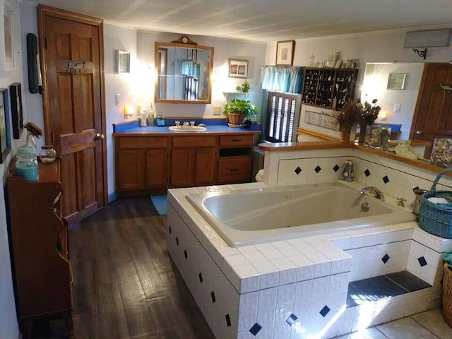 bathroom featuring vanity, wood finished floors, and a whirlpool tub