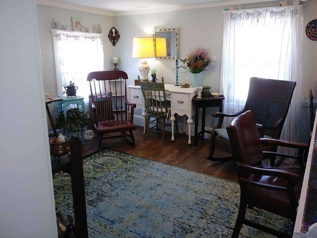 living area featuring crown molding and wood finished floors