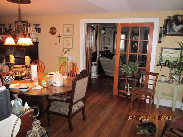 dining area featuring a notable chandelier and wood finished floors